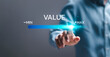 © Pakin - Businessman touch virtual screen of progress bar with the word VALUE for growth value, increase value, value added and business growth concept.