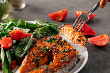 Wall Mural - Eating gourmet grilled salmon steak with vegetables