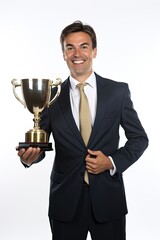 Businessman standing with pride holding a trophy isolated over white background.