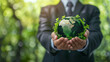 Businessman holding mini global ecosystem world to Organization Sustainable development environmental on green background