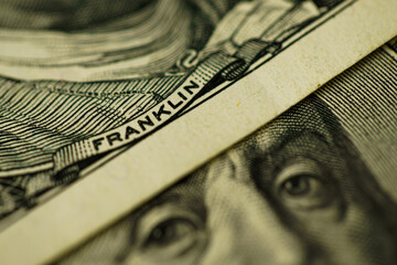 100 dollar bill with Benjamin Franklin face macro shot. Close up portrait of Benjamin Franklin on one hundred dollar bill