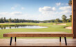 © adynue - empty wooden table for product presentation on blurry golf course background