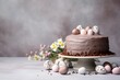  a cake sitting on top of a cake plate covered in chocolate frosting and decorated with small speckled eggs next to a bouquet of daisies and daisies.