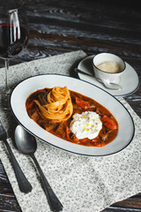 Wall Mural - Appetizing pasta with tomato sauce and cheese on a dark wooden table. Restaurant food service.