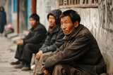 Fototapeta  - Poor, unemployed and homeless men sitting on the street of Asia, selective focus