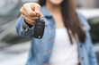 © Pormezz - transportation rental automotive business concept. Close up hands of rental auto agent giving car remote key to client to travel sightseeing.