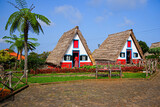 Fototapeta Krajobraz - Traditional rural Madeirense farmhouse in Santana, built during the settlement of Madeira island in the Atlantic Ocean by the Portuguese. Is has sloping triangular rooftops, protected by straw