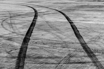 Wall Mural - Tire track mark on asphalt tarmac road race track texture and background, Abstract background black tire tracks skid on asphalt road in racing circuit, Tire mark skid mark on asphalt road.