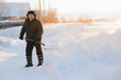 © Parilov - Elderly man cleaning snow with shovel in village after snowstorm. Old pensioner works as janitor, sunlight.