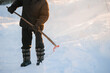 © Parilov - City service cleaning snow winter with shovel after snowstorm, sunlight