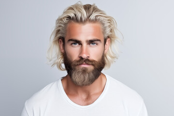 Wall Mural - Handsome Caucasian bearded blonde man contented expression and healthy hair looking at camera
