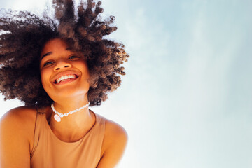 Wall Mural - Close up portrait of happy african american female teenage smiling sweetly at the camera