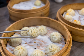 Poster - Steamed xiaolongbao served in a traditional steaming basket