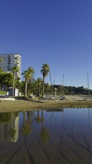 Wall Mural - Walk through a sunny city. Walk through the city of Benicassim by the sea in winter. Warm sunny day at the end of December. Boats and catamarans lie on the yellow sand of the beach. Province of