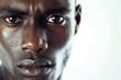 Intense portrait of an African man, focused and serious, white background