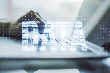 Wall Mural - creative data word sign and hands typing on laptop on background. multiexposure