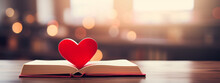 Close Up Of A Red Heart On A Paper Book.