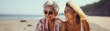 © Lione - Young girl with blonde hair with her grandmother. They are sitting on the beach on a sunny day