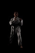 © Nikola Spasenoski - Young girl exercising karate. Child in kimono against black background.
