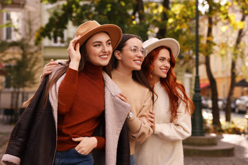 Wall Mural - Portrait of happy friends posing outdoors on autumn day