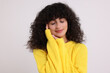 © New Africa - Young woman in stylish yellow sweater on white background