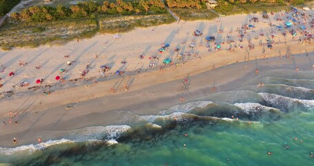 Wall Mural - Nokomis beach with soft white sand in Sarasota county, USA. Many people enjoying vacation time bathing in warm gulf water and tanning under hot Florida sun at sunset