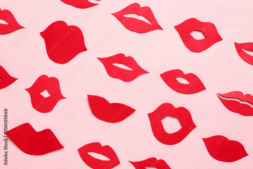 Red paper lips on pink background