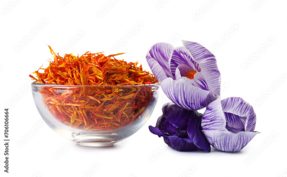 Bowl of dried saffron threads and crocus flowers isolated on white background