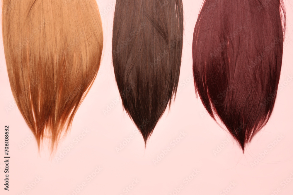 Beautiful hair strands on pink background