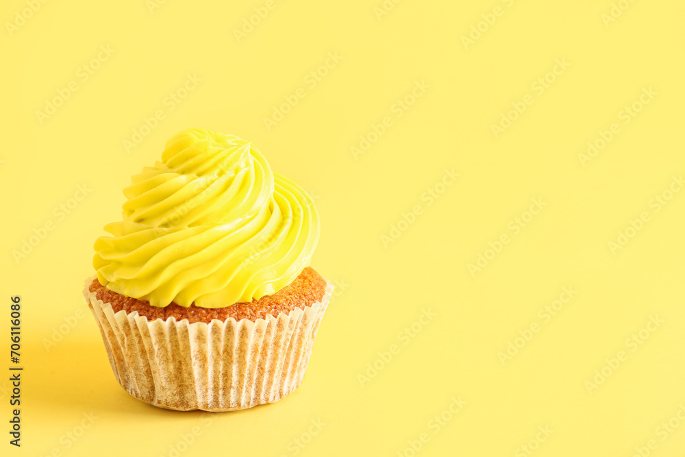 Tasty cupcake on yellow background