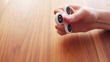 Using a fidget spinner on table in slow motion