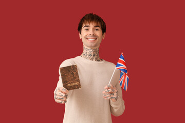 Sticker - Handsome young man with UK flag and passport on red background. Immigration concept