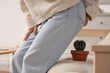 © Pixel-Shot - Mature woman with hemorrhoids and cactus on sofa at home, closeup