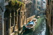 A narrow canal street in Venice, Italy