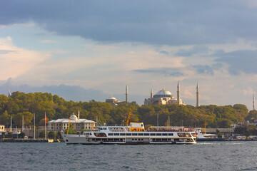 Istanbul background photo. Ferry and Hagia Sophia aka Ayasofya at sunset