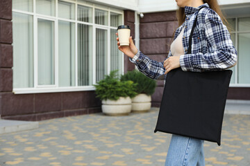 Wall Mural - A woman with coffee and a bag on her shoulder