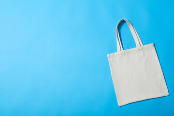 Wall Mural - A white bag lies on a blue background