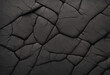Black stone background. Dark gray rock texture. Rough stone surface with cracks.