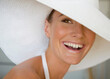 © fStop - Close up of a young woman wearing a white hat smiling