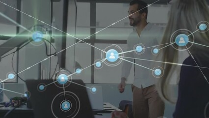 Wall Mural - Animation of network of connections over diverse colleagues using laptops in office