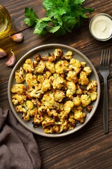 Wall Mural - Roasted cauliflower on wooden background