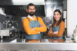 Corporate image of a young entrepreneurial couple of a multiracial coffee shop.