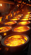 Rows of foundry ladles filled with fiery molten metal during the casting process.