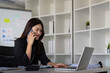 © Natee Meepian - Happy confident businesswoman talking on the phone. Smiling female business person talking work using talking on the phone at office sitting at desk