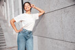 © halayalex - Young beautiful smiling hipster woman in trendy summer white t-shirt and jeans clothes. Carefree woman, posing in the street at sunny day. Positive model outdoors. Cheerful and happy