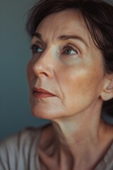 Wall Mural - A close-up shot of a woman looking up. Perfect for adding a sense of curiosity and wonder to any project