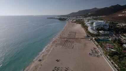 Wall Mural - The drone aerial footage of Morro Jable and Playa del Matorral in Fuerteventura Island, Spain. Morro Jable is the most populated town in the municipality of Pájara in the south of Fuerteventura.