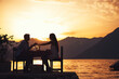 © NDABCREATIVITY - Couple is having a private event dinner on a tropical beach during sunset time