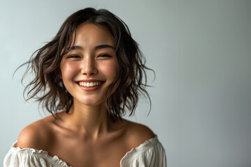 Pretty young Asian woman smiling.