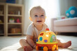 Smiling blond baby playing with colorful toys while sitting on the floor in a sunny kids room at home. Joyful kid toddler play with educational toy in kindergarten. Early childhood development.
